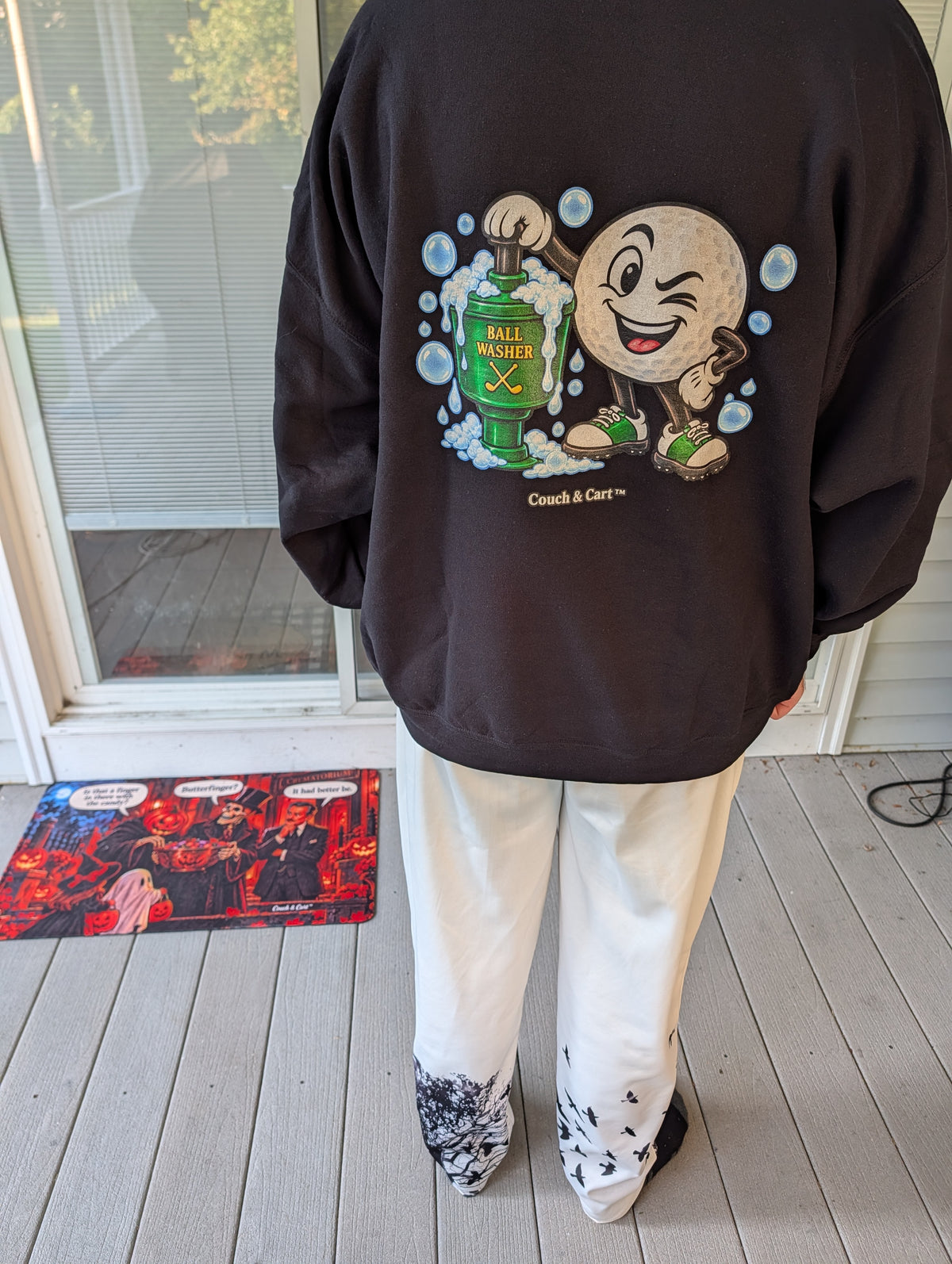 Real photo: back of the black Golf Ball Washer hoodie showing the winking golf ball cartoon