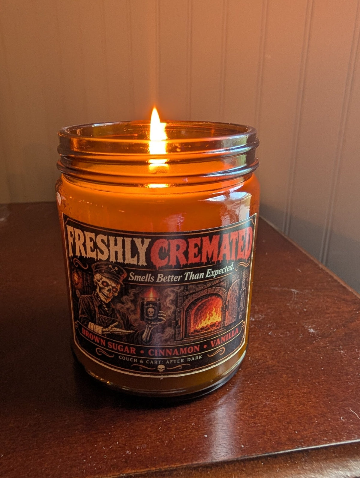 Real photo of the lit Freshly Cremated funny Halloween soy candle in an amber jar, brown sugar cinnamon vanilla – Couch & Cart