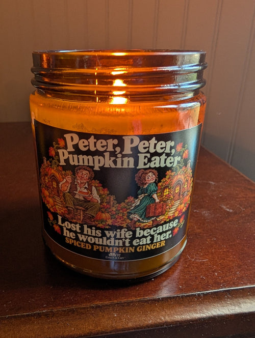 Real photo of the lit Peter Peter Pumpkin Eater adult humor candle, Spiced Pumpkin Ginger scent – Couch & Cart